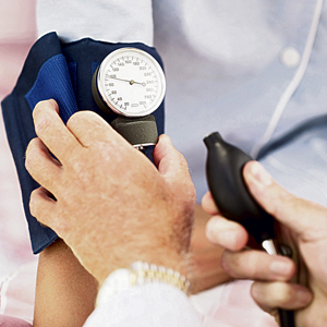 Pair of Human Hands Checking the Blood Pressure of a Patient